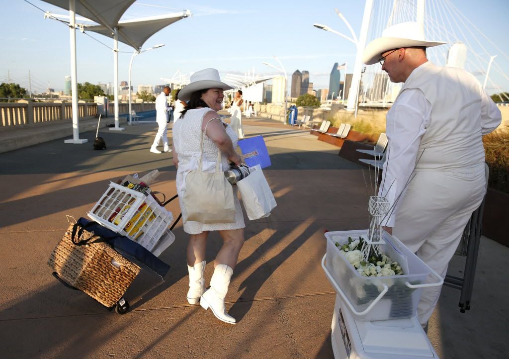 Donna VanderGrinten and Jim Michalek carry food, chairs and a centerpiece for the inaugural...