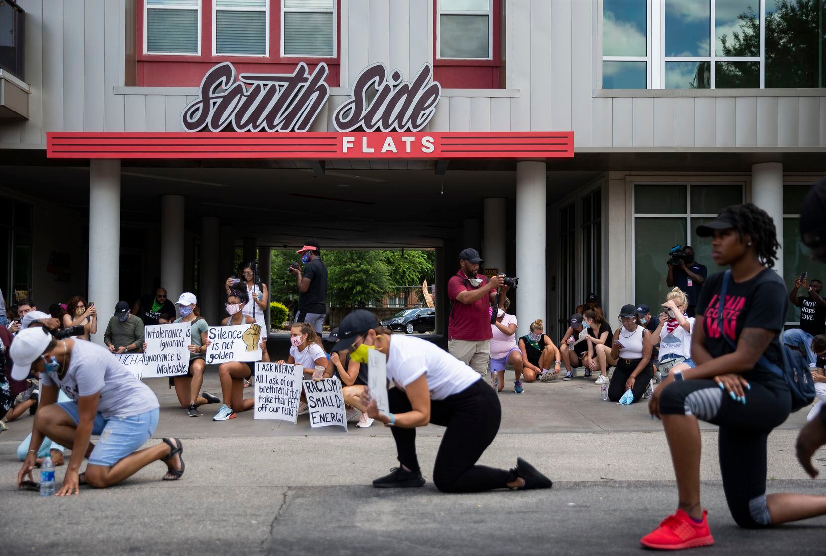 Protesters had an eight-minute moment of silence to honor George Floyd in front of South Side Flats, the apartment complex where former Dallas police officer Amber Guyger fatally shot Botham Jean in September 2018, during the National Injustice Peaceful Rally against police brutality in Dallas on Sunday. (Juan Figueroa/Staff Photographer)