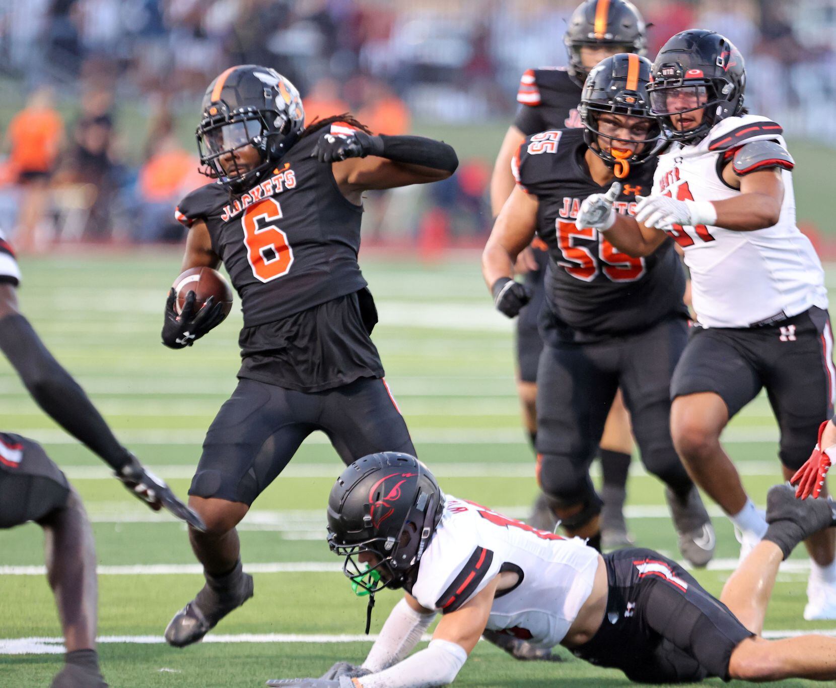Rockwall RB Ashten Emory (6) picks up a couple of yards in heavy traffic during the first...