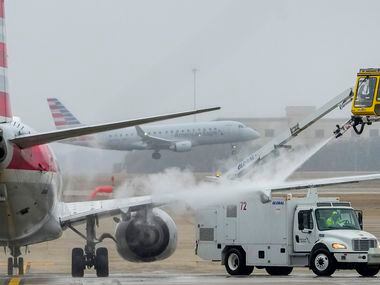 An American Airlines aircraft undergoes deicing procetures on Monday, Jan. 30, 2023, at DFW...