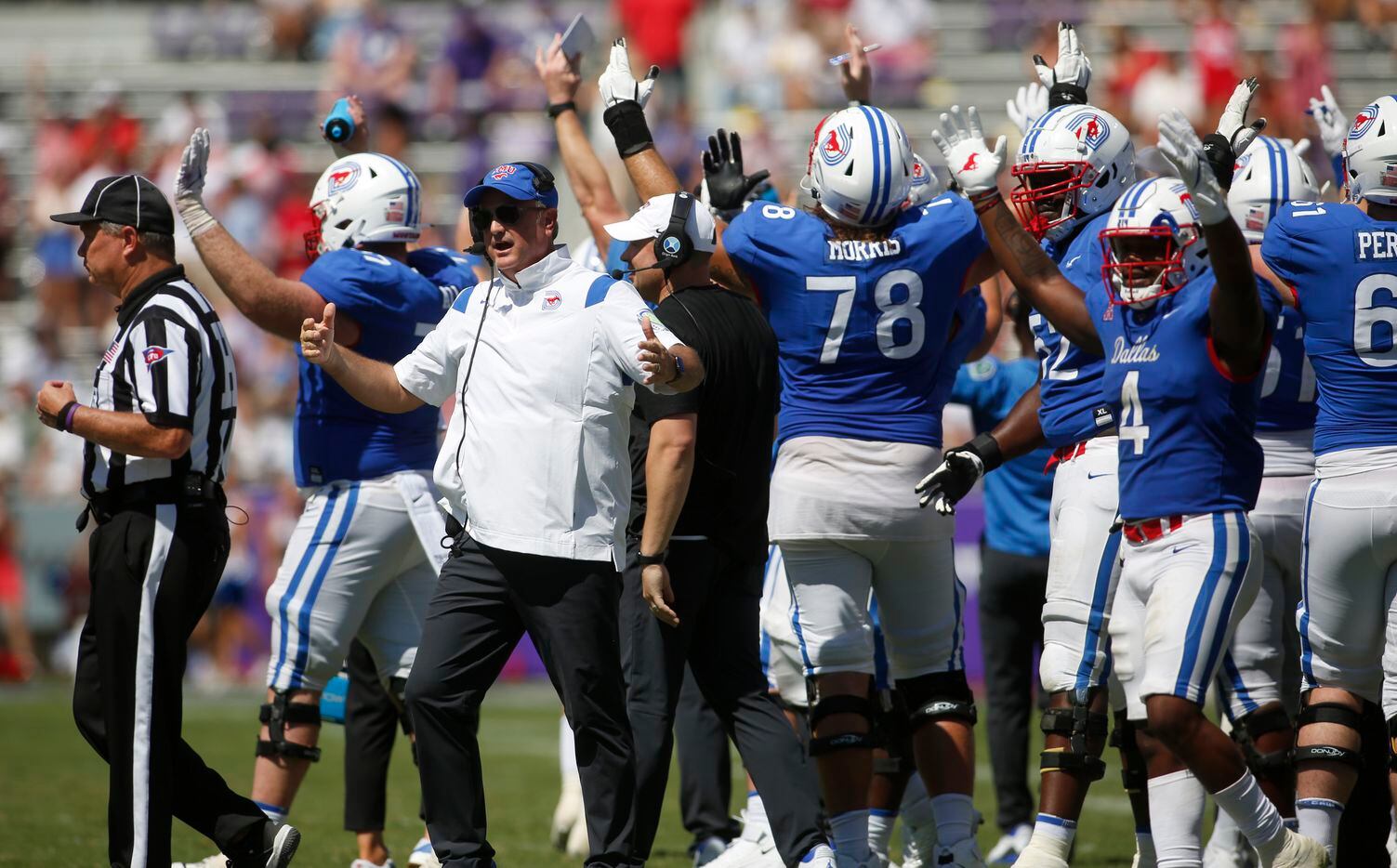 SMU coach Sonny Dykes leads his team's effort to question a call after the replay was shown...