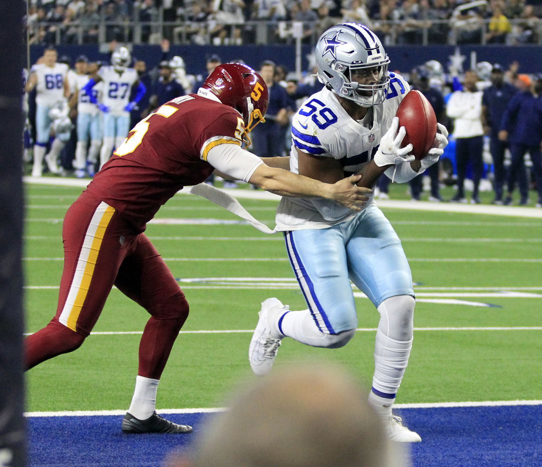 Dallas Cowboys defensive end Chauncey Golston (59) recovers a blocked punt for a touchdown during the second half of a NFL football game against the Washington Football Team at AT&T Stadium in Arlington, TX on Sunday, December 26, 2021.