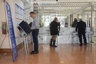 People participate in early voting at the George L. Allen Sr. Courts Building on Feb. 20,...