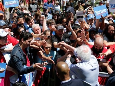 Democratic presidential candidate Sen. Bernie Sanders, I-Vt., shakes hands with people after...