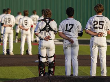 Rockwall-Heath players, including catcher Kevin Bazzell (9), pitcher Josh Hoover (17) and first baseman Katson Mason (25) stand for the national anthem before a district 10-6A high school baseball game against North Mesquite on Thursday, April 1, 2021, in Rockwall.