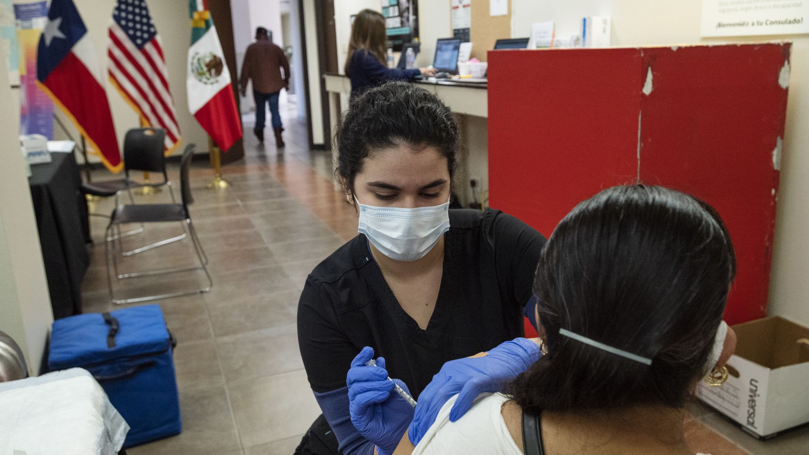 Medical assistant Julia Robles administers a COVID-19 vaccination to a woman at the Mexican Consulate in Dallas, on Saturday, March 27, 2021, in Dallas.