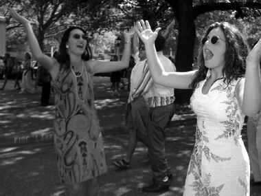 Rebecca Sanabria (right) and other associates of the Alpha Chi Omega sorority perform the...