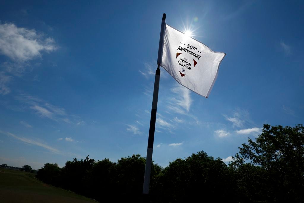 The 50th Anniversary AT&T Byron Nelson golf tournament pin flag whips in the wind at the new...