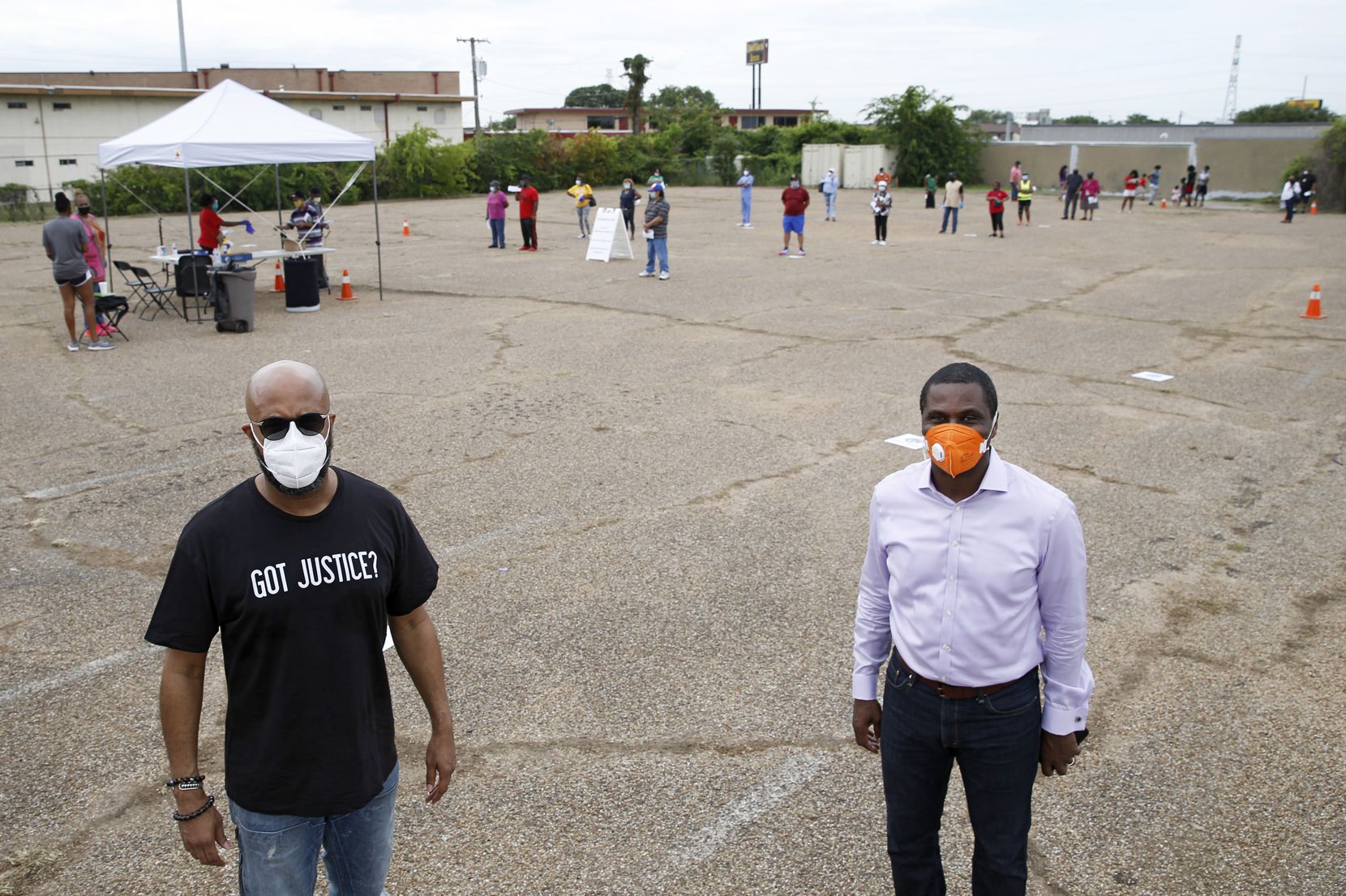 Pastor Frederick D. Haynes (left) of Friendship-West Baptist Church of Dallas and Pastor Richie L. Butler (right) of St. Paul United Methodist Church of Dallas pose for a portrait while people wait in line at a free testing site for coronavirus in Dallas, on Thursday, May 28, 2020.
