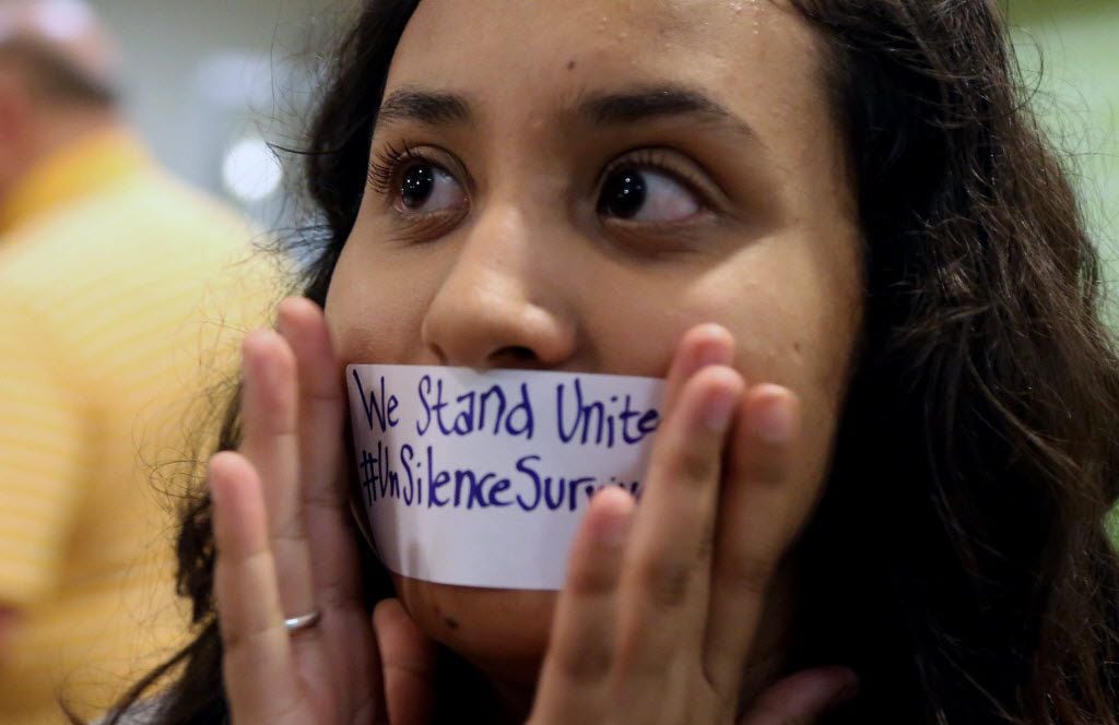 Baylor junior Julieth Reyes cover her mouth with tape during a rally against sexual assault...