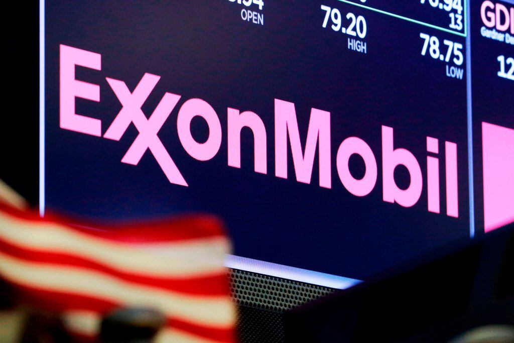 The logo for Exxon Mobil appears above a trading post on the floor of the New York Stock...