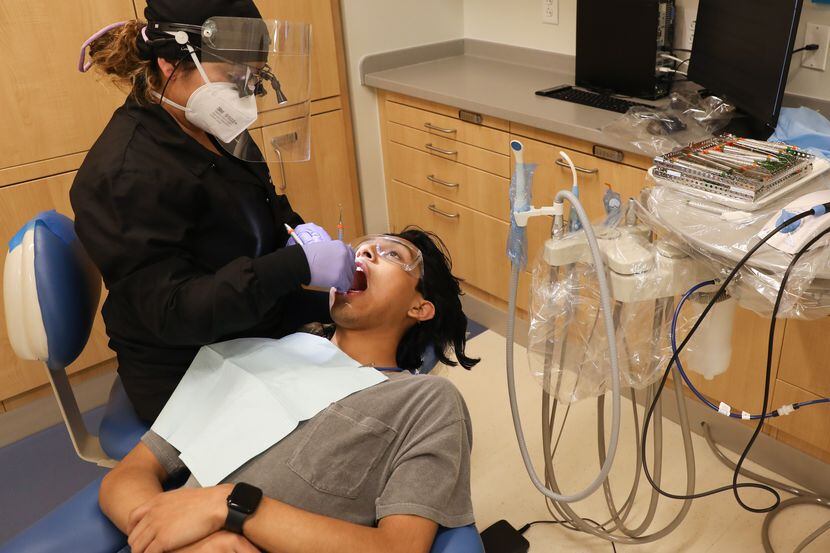 Estudiantes de higiene dental de primer año como Mari Rodriguez (izq.) ensayan en pacientes...