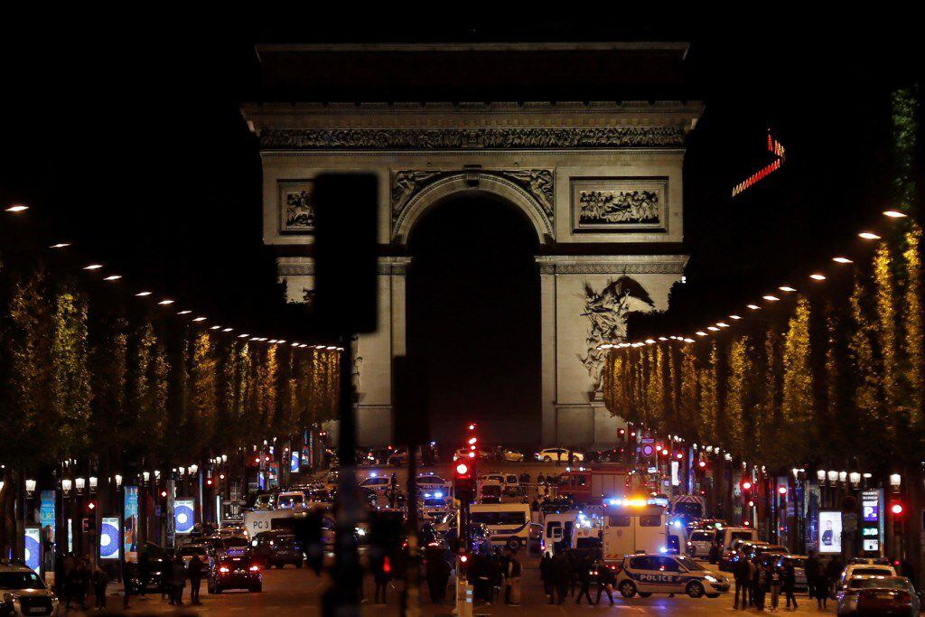Police officers block the access to the Champs Elysees in Paris after a shooting on April...
