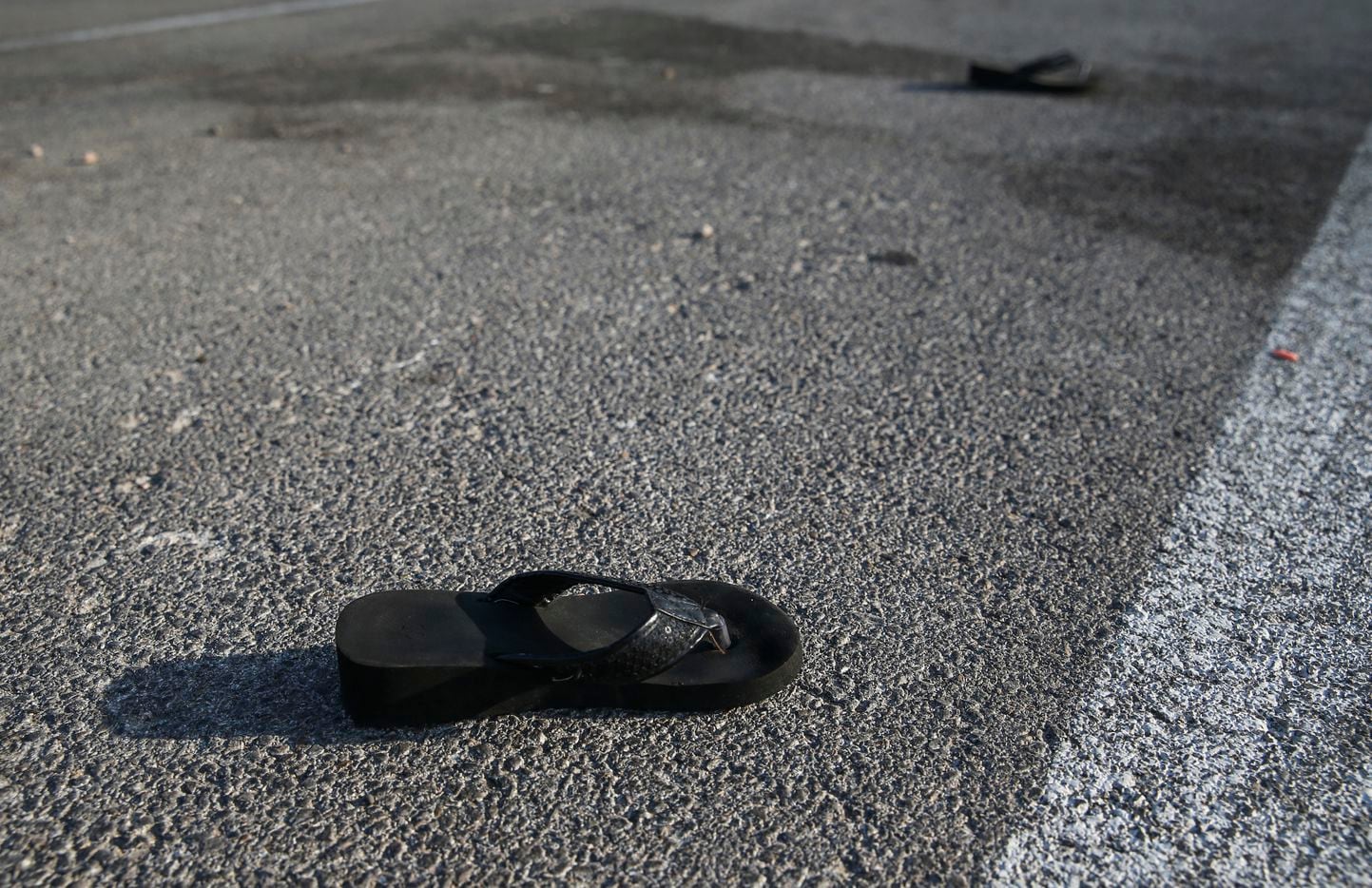A pair of lost sandals are seen Sunday, Sept. 1, 2019 in the parking lot of the Odessa,...
