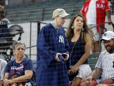 A fan wears a judge’s robe before a MLB game between the New York Yankees and Texas Rangers...