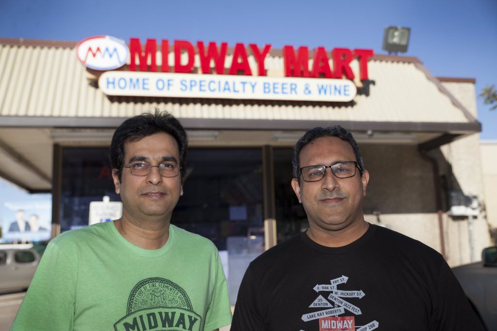 Shaun Tapia, left, and Shakeel Merchant, owners of Midway Mart, pose outside their current...