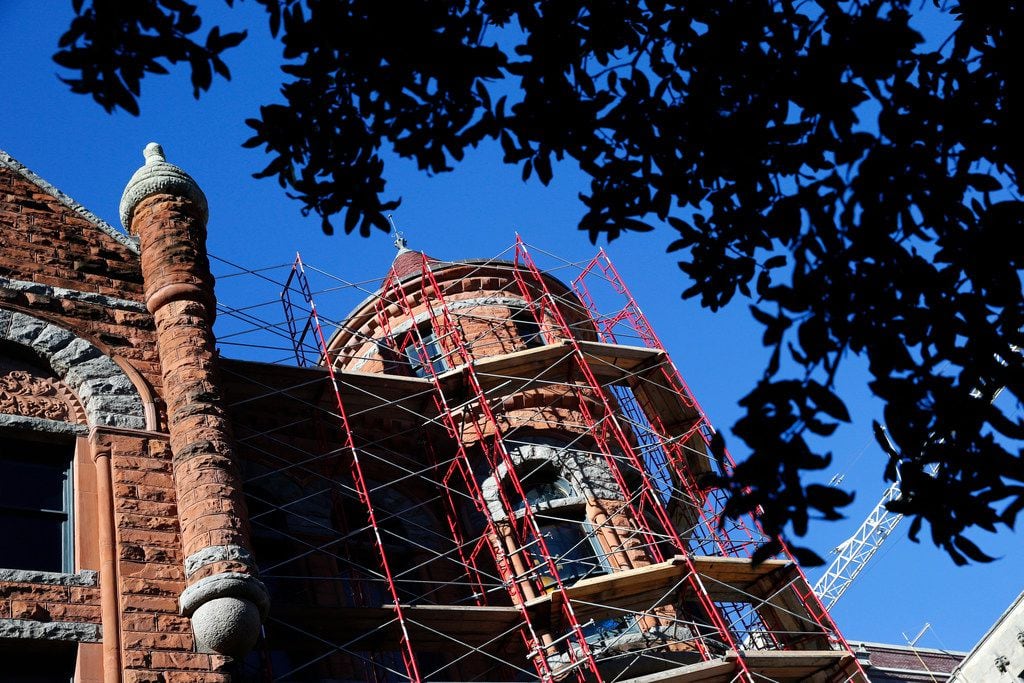 Scaffolding covers the outside of Old Red Courthouse in order to clean the brick and replace...