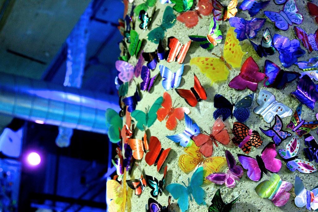 Thousands of soda-can butterflies adorn the tops of columns in the gallery level of Spark....