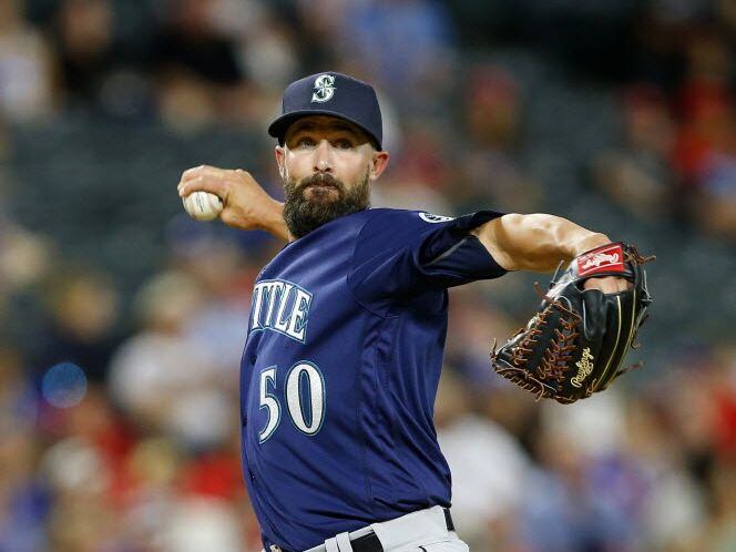 Seattle Mariners relief pitcher Nick Vincent (50) turns and throws to first to hold Texas...