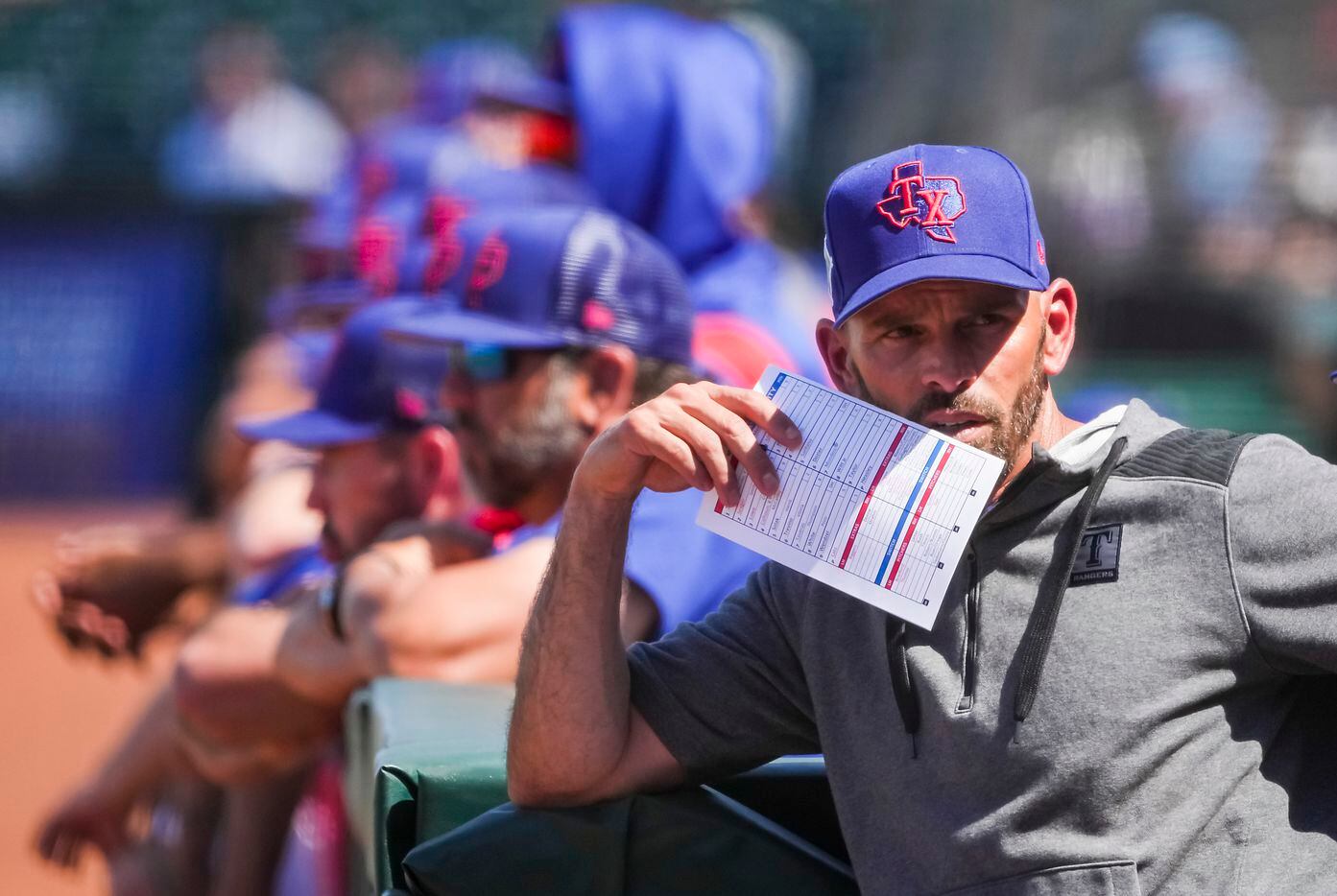 Texas Rangers manager Chris Woodward looks on from the dugout during the second inning of a...