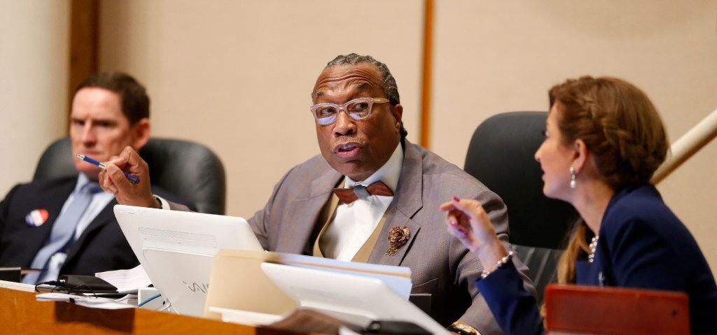 Dallas County Commissioner John Wiley Price (center) speaks next to County Judge Clay...