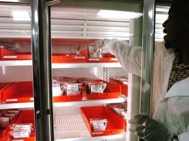 Hospital technician Gregory Whitehead adjusts dwindling supplies of blood on the shelves at the American Red Cross Blood Services Center in Dallas.
