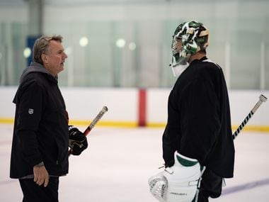 Dallas Stars interim head coach Rick Bowness talks with goalie Ben Bishop as the Dallas Stars work out in their 'bubble' in Edmonton, in Alberta, Canada, on July 28, 2020. 