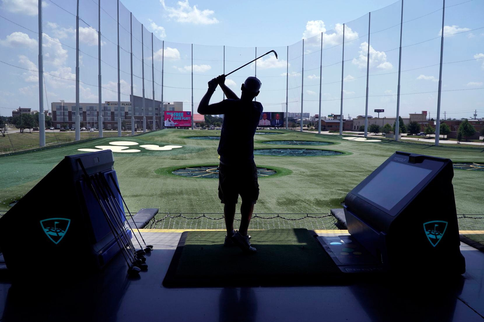 Jared Tiner practices his swing at Topgolf in The Colony on June 29, 2022.