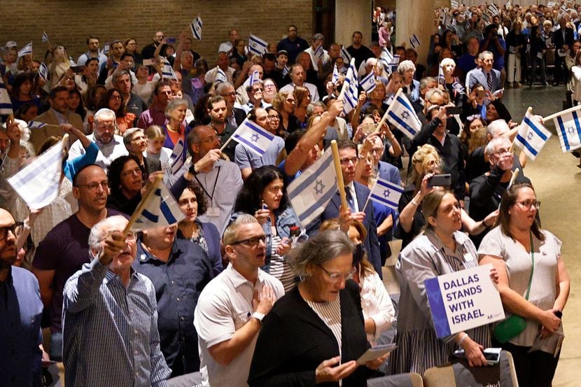 Supporters of Israel hold Israel flags during a community solidarity gathering for Israel at...