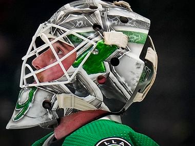 Dallas Stars goaltender Jake Oettinger looks up during a timeout during the second period of...