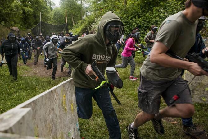 
Interns at Amazon march off to compete in a paintball match against interns from Microsoft...