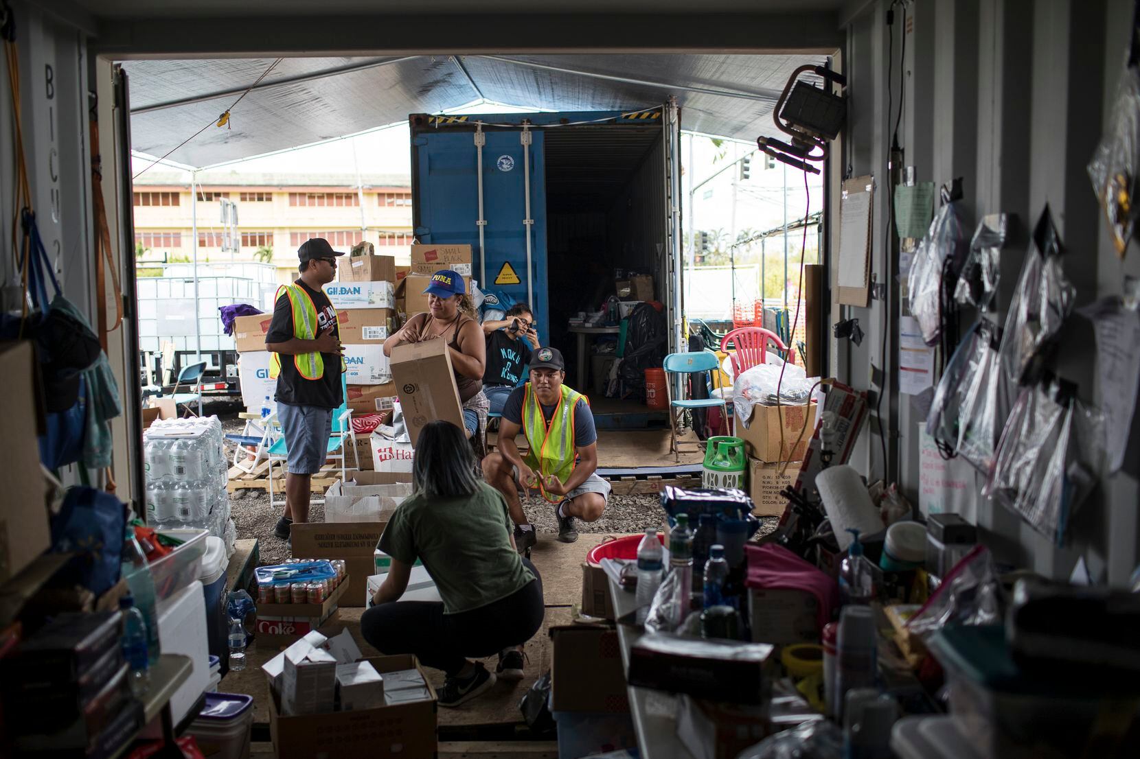 Volunteers organize donated items at Puuhonua o Puna, a community organization serving...