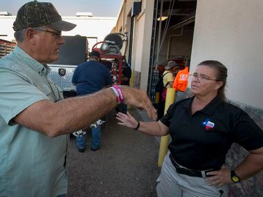Brewster County Sheriff Ronny Dodson talks with Dawn Keller, West Texas Division Leader for...