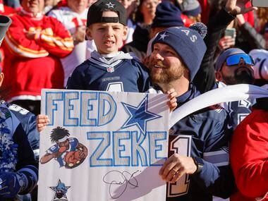 Tommy Selsor, 29, holds his son Parker Selsor, 7, before the first half of an NFL football...