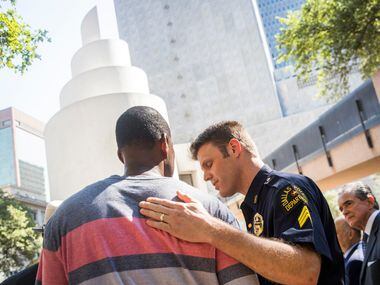 Dallas police Sgt. Dan Mosher hugs Odell Edwards, the father of Jordan Edwards, a...