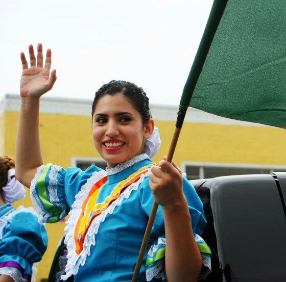 A folkorico dancer waves during a Cinco de Mayo parade.