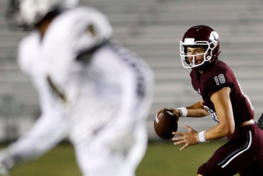 Ennis quarterback Collin Drake (18) rolls out in search of an open receiver during first...