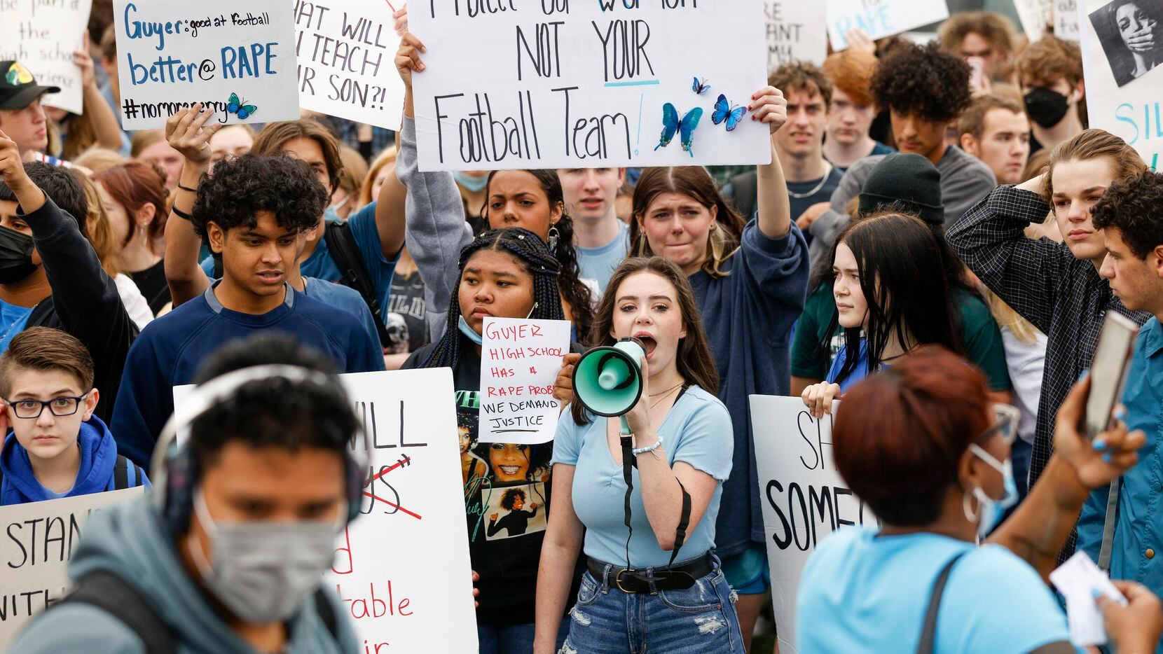 Guyer High School senior Chaney Tipton, 17 (center), speaks into a megaphone demanding...