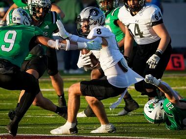 Denton Guyer wide receiver Sutton Lee (8) is brought down by Southlake Carroll defensive...