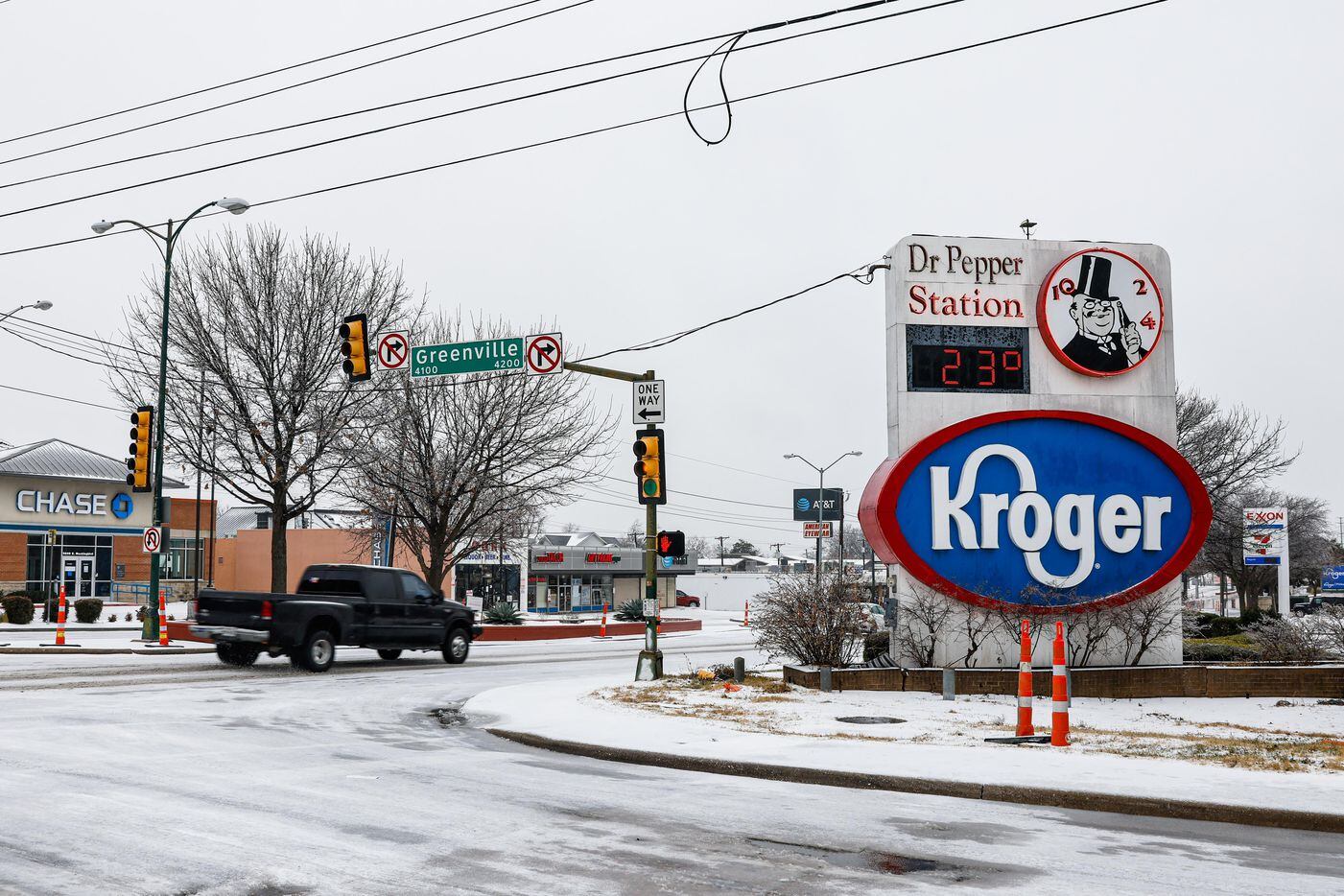 People drive on a snowy E Mockingbird Ln and Greenville in Dallas on Thursday, February 3,...
