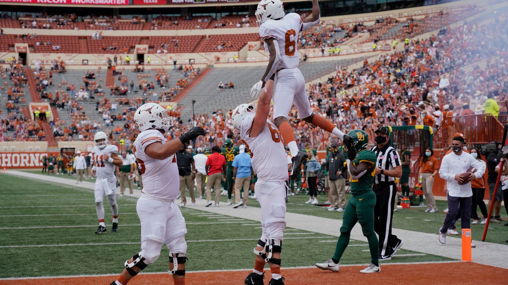 Texas' Joshua Moore (6) celebrates his touchdown catch with teammates against Baylor during...