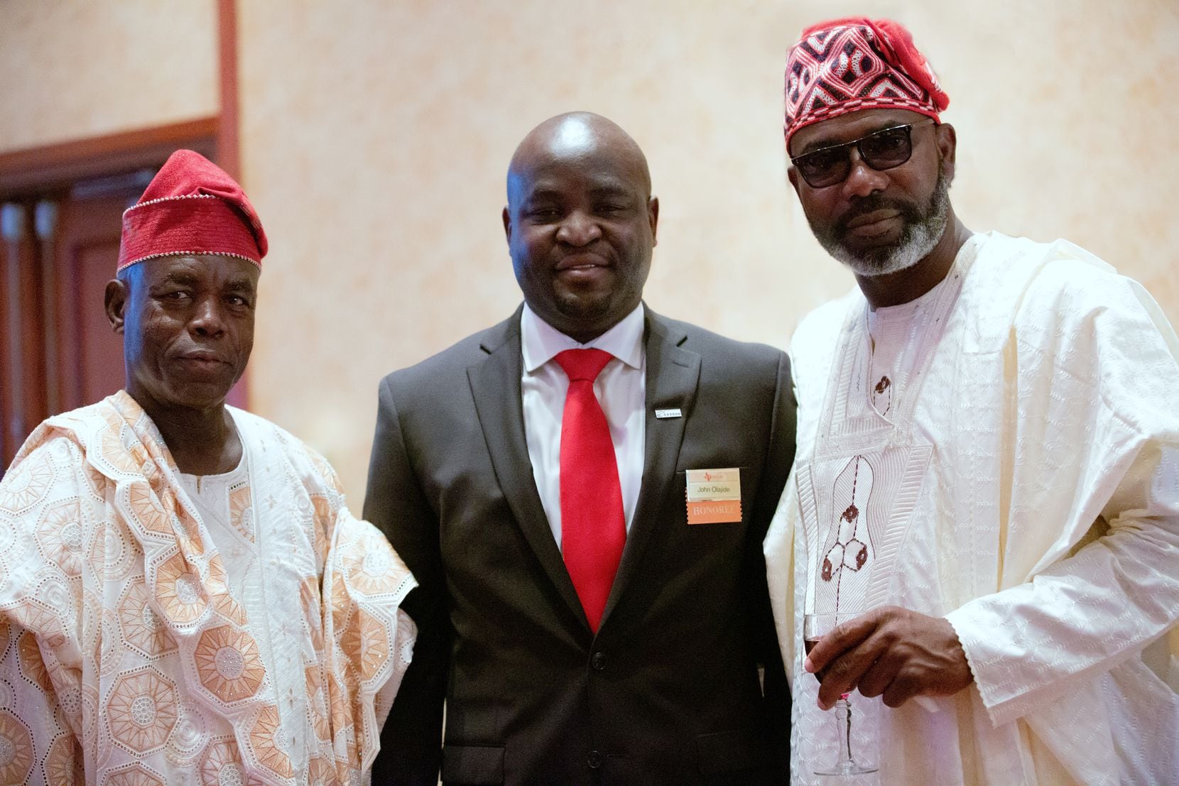 John Olajide, center, stands with his father, Daniel Olajide, right, and his uncle, Kunle Shonaike, at the Distinguished Alumnus reception at the University of Texas at Dallas in 2016.