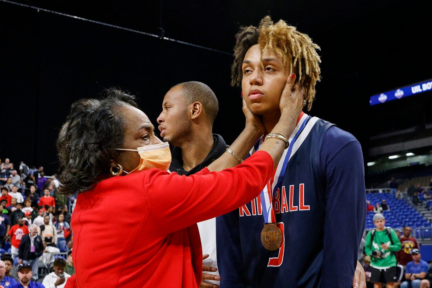 Dallas ISD Trustee Joyce Foreman consoles Kimball guard Chauncey Gibson (3) after presenting...