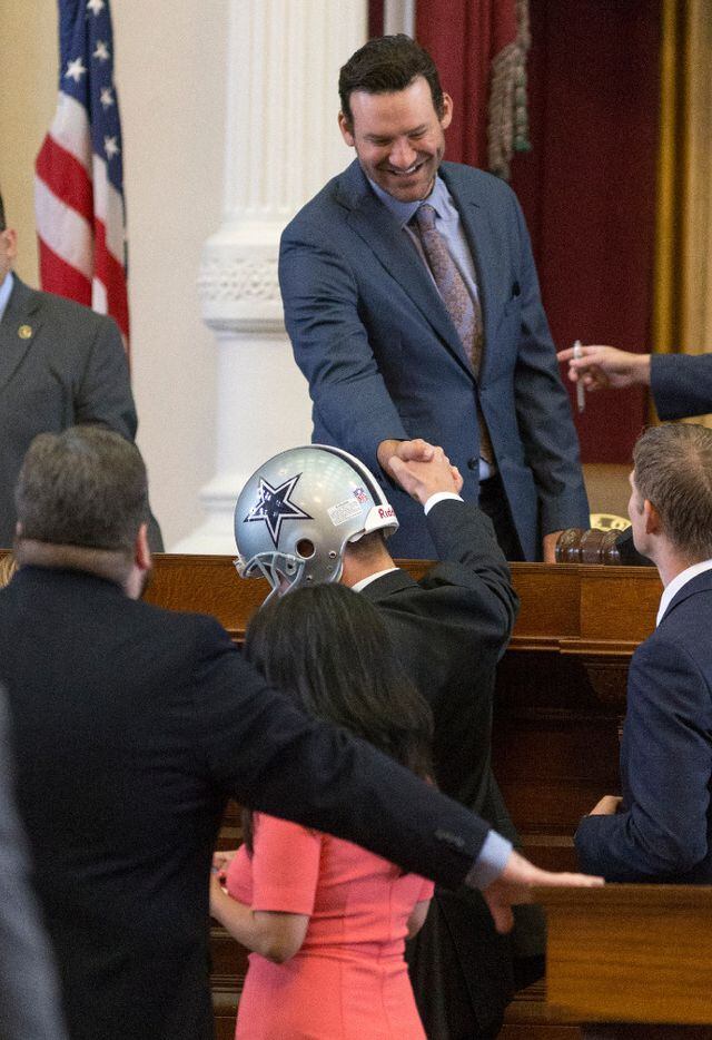 Former Dallas Cowboys quarterback Tony Romo shakes the hand of Rep. Jeff Leach, R-Plano, as he is recognized by the House at the Texas Capitol in Austin, Wednesday, May 3, 2017.