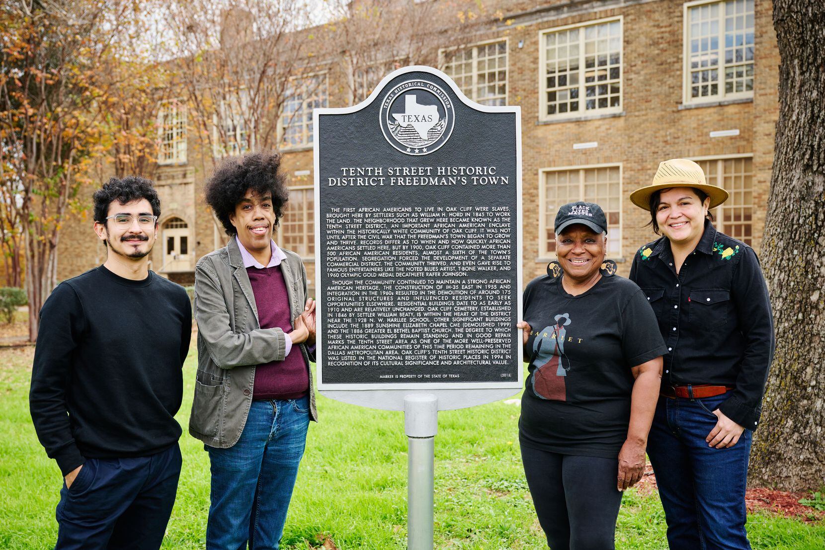 Standing alongside the historical marker for the Tenth Street Historic District freedman's...