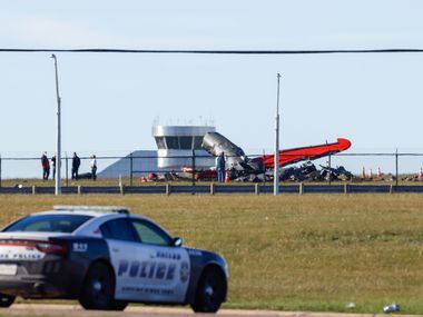 Police respond to a mid-air collision between two planes within the fence line of the Dallas...