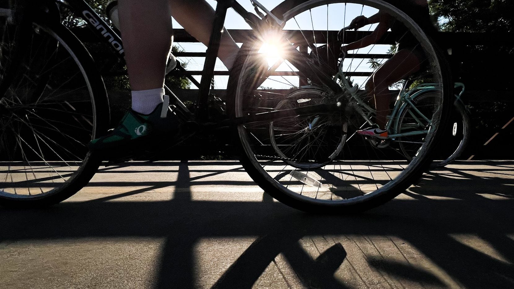 Cyclists ride their bikes on the trail at White Rock Lake in Dallas on Tuesday, July 12,...