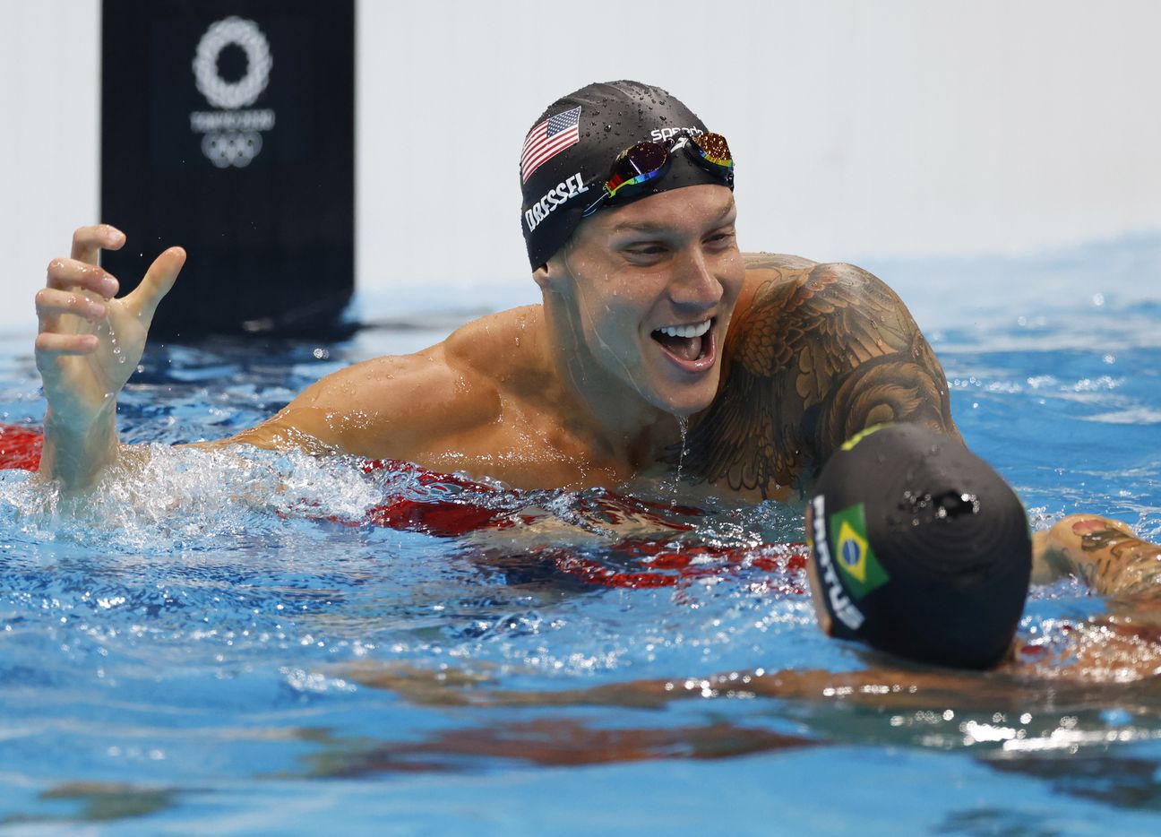 USA’s Caeleb Dressel celebrates with Brazil’s Bruno Fratus after winning the men’s 50 meter...