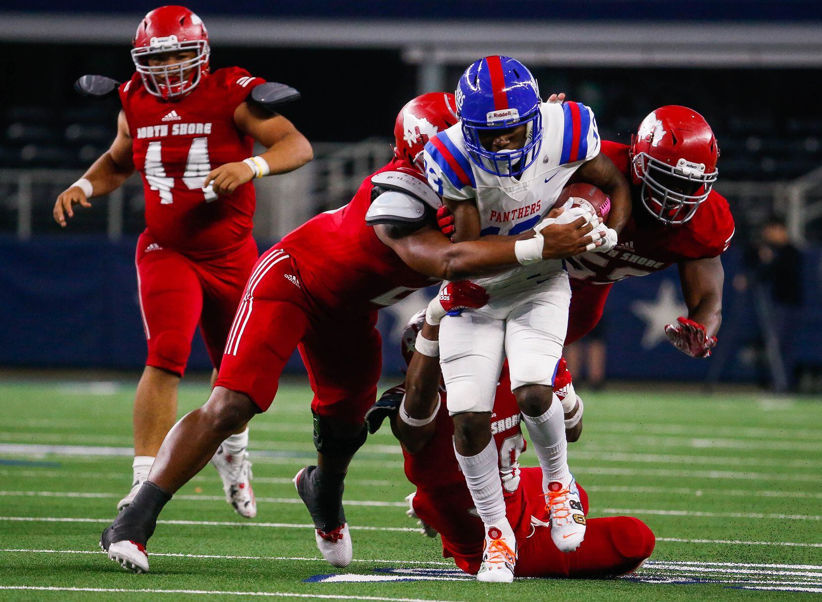 Duncanville's Roderick Daniels (13) attempts to breakthrough the North Shore defense in the...