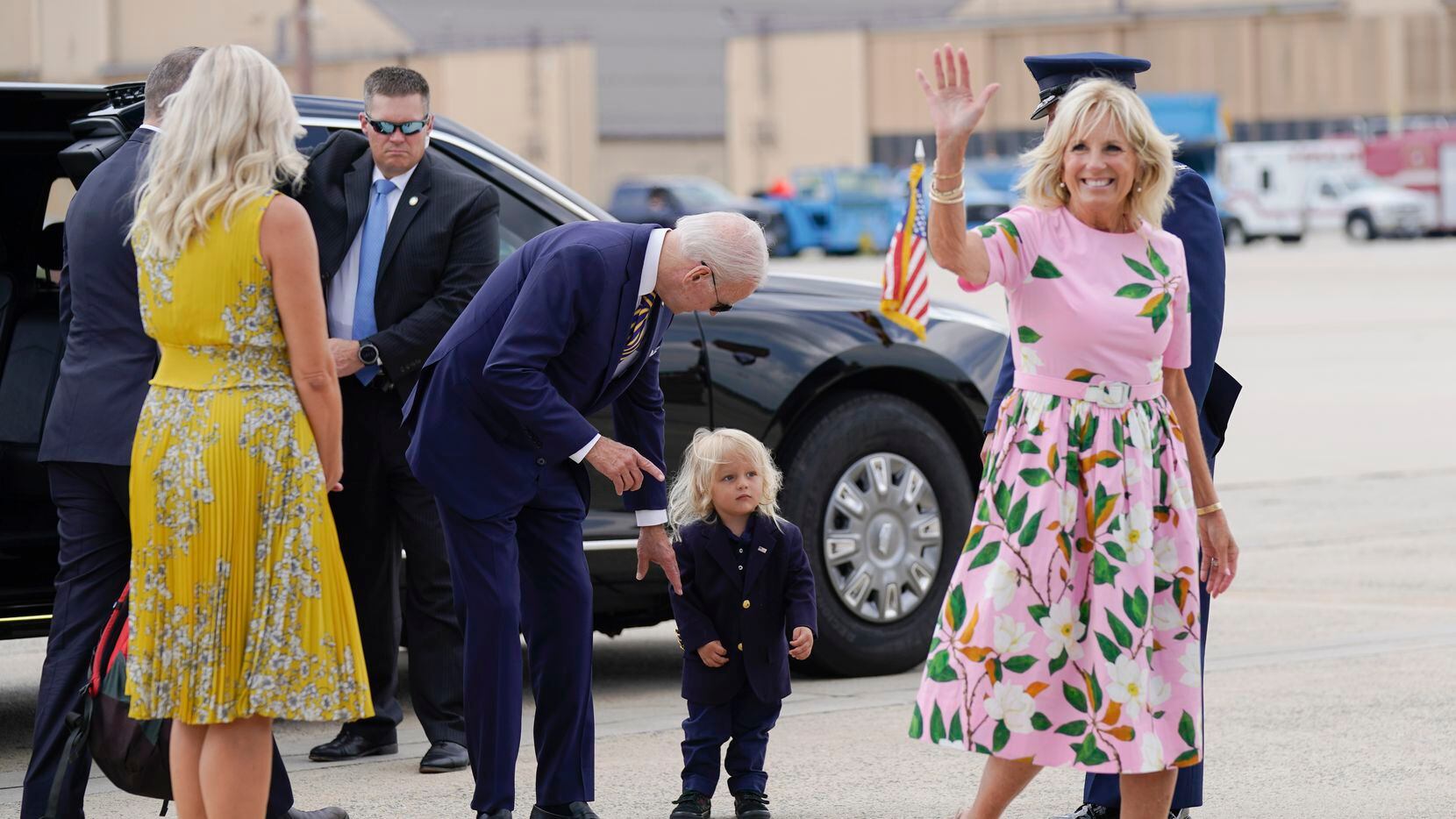 President Joe Biden looks at his grandson Beau Biden as first lady Jill Biden waves and...